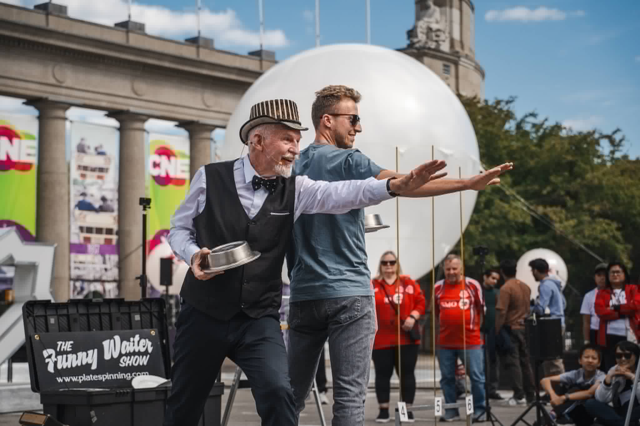 John Park and an audience volunteer performing back-to-back at the CNE in Toronto