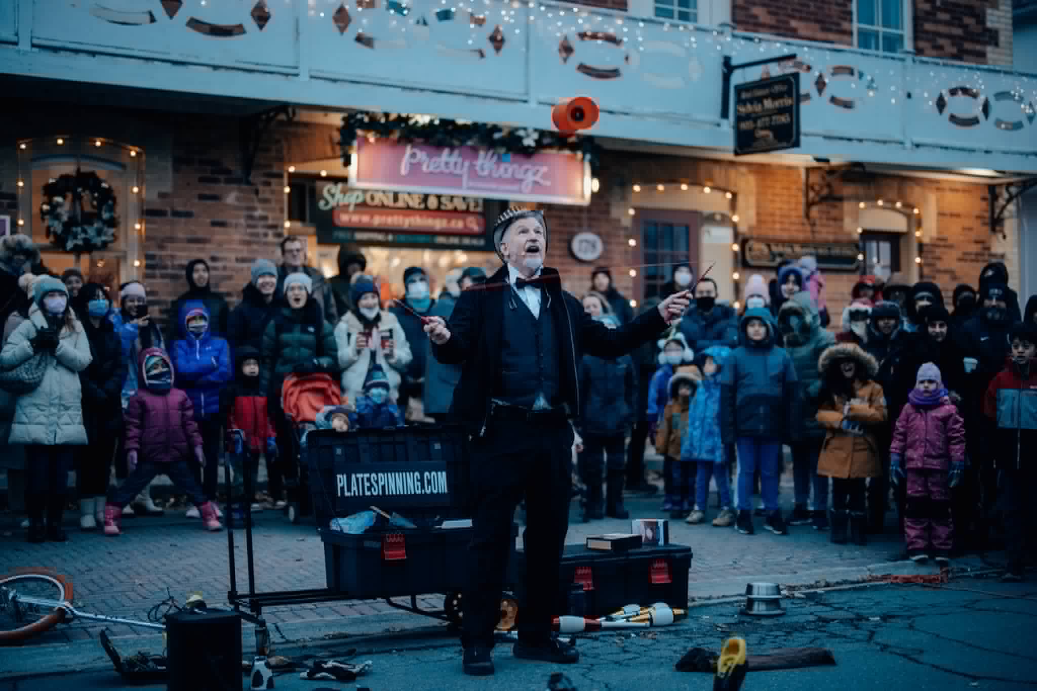Evening holiday street show with a big crowd watching The One Man Circus